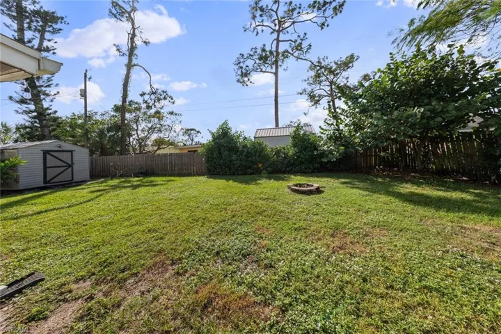 View of yard with an outdoor fire pit