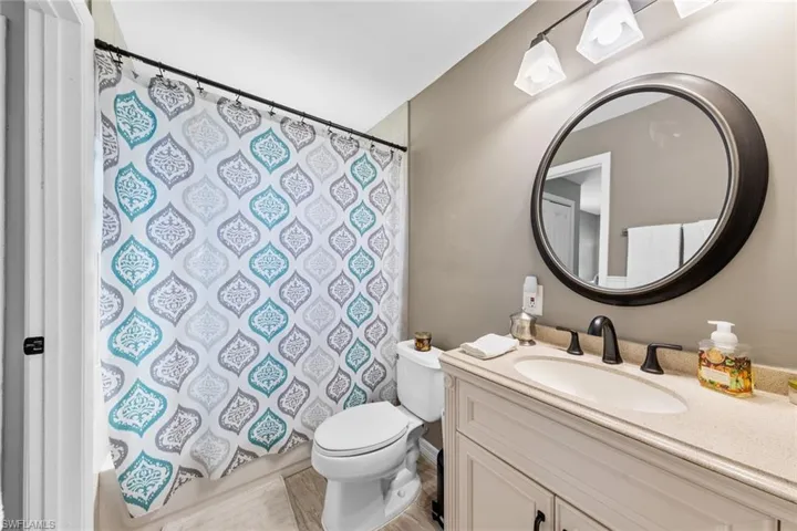 Full bathroom with vanity, toilet, and shower / tub combo