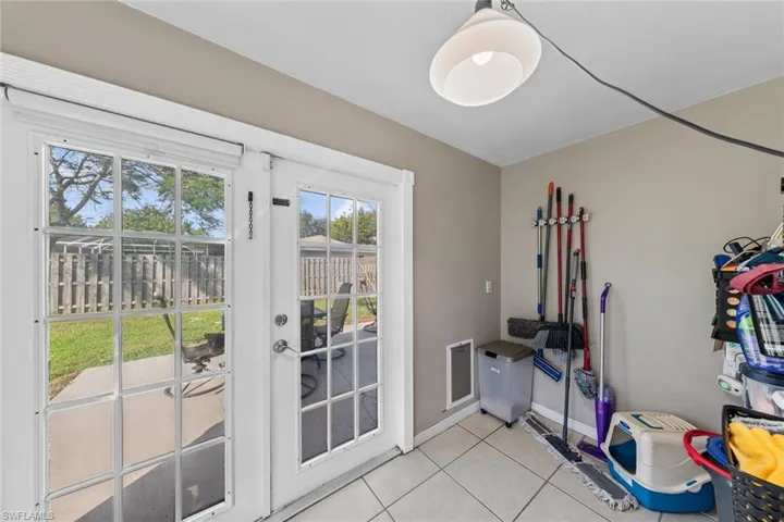 Doorway with light tile patterned floors