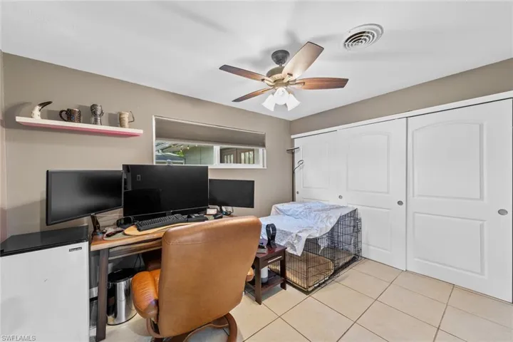 Office space featuring ceiling fan and light tile patterned floors
