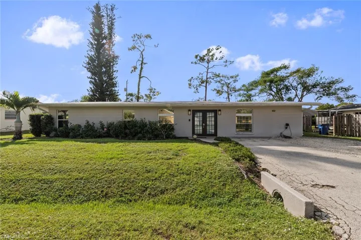 Ranch-style house with french doors and a front yard