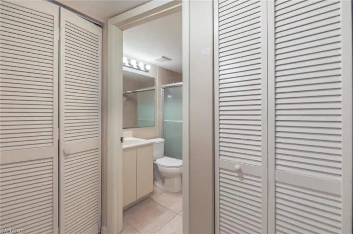 Bathroom with tile flooring, vanity, and toilet