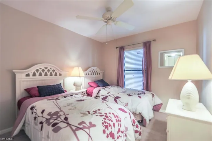 Carpeted bedroom with ceiling fan