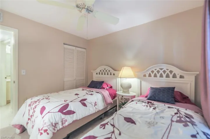 Bedroom with ceiling fan and a closet