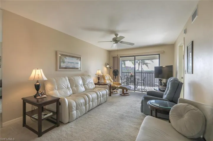 Living room with carpet and ceiling fan