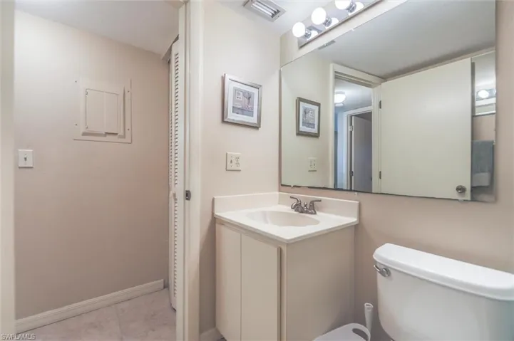 Bathroom with tile flooring, oversized vanity, and toilet