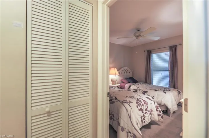 Bedroom with carpet flooring, a closet, and ceiling fan