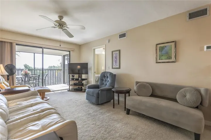 Living room featuring ceiling fan and carpet floors