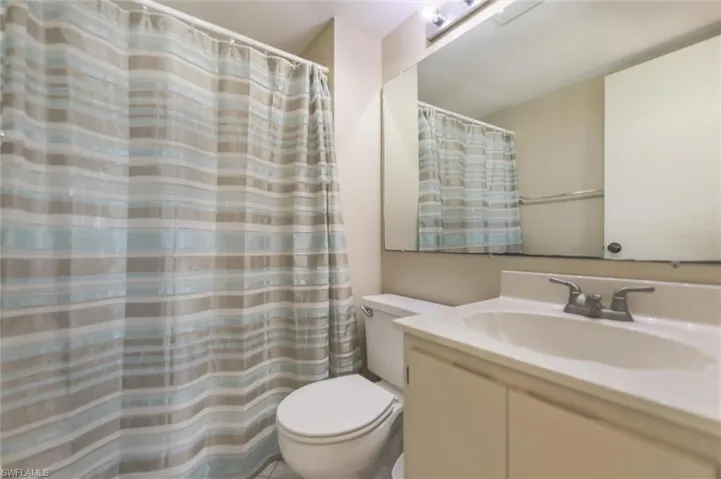 Bathroom with toilet and large vanity