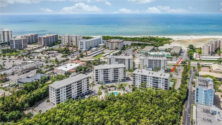 Drone / aerial view featuring a beach view and a water view