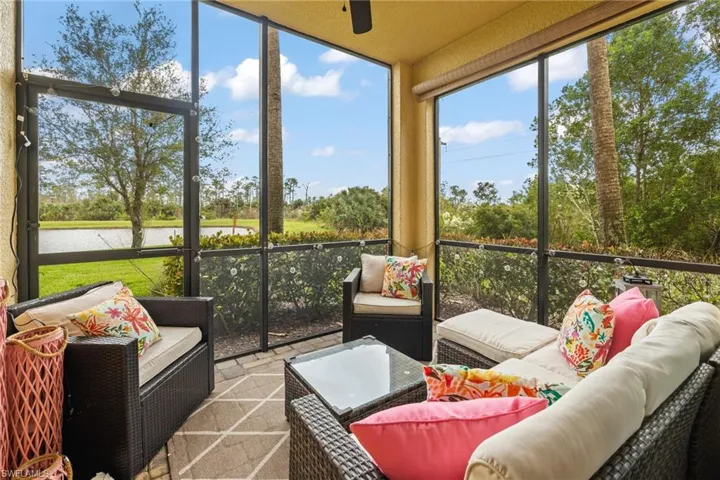 Sunroom / solarium featuring a water view and ceiling fan