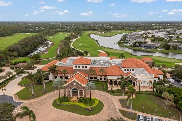 Birds eye view of property with a water view