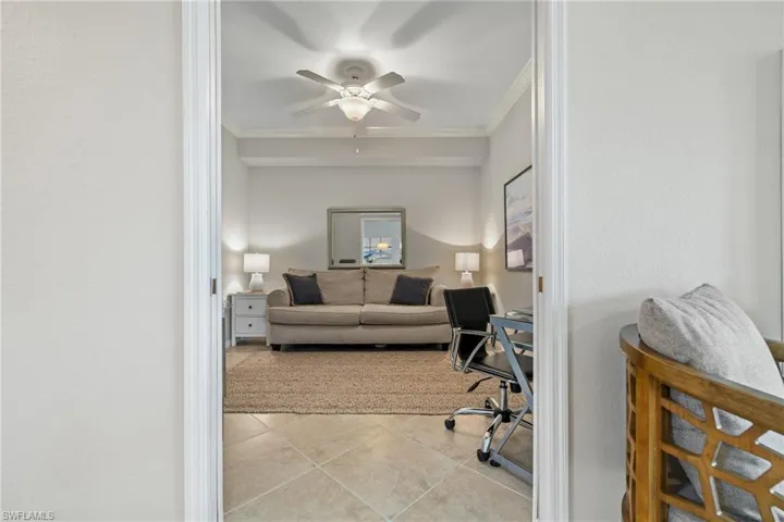 Office featuring ceiling fan, light tile patterned floors, and ornamental molding