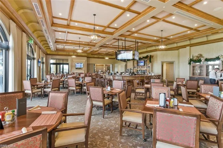 Dining space featuring carpet flooring, beamed ceiling, a chandelier, and coffered ceiling