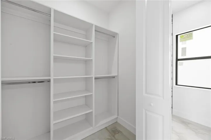 Spacious closet featuring light hardwood / wood-style floors