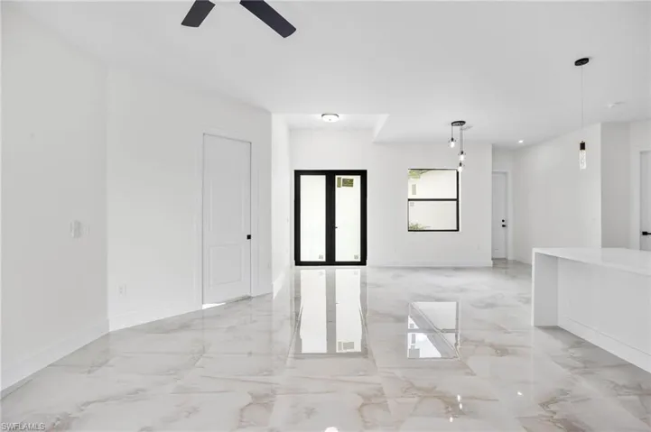 Spare room featuring ceiling fan and french doors