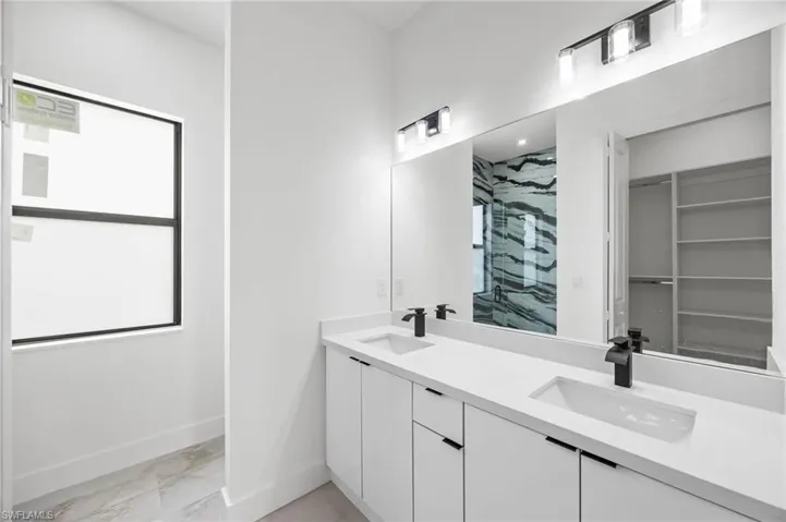 Bathroom with vanity and tiled shower