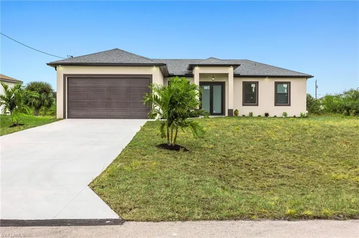Prairie-style home with a garage and a front lawn