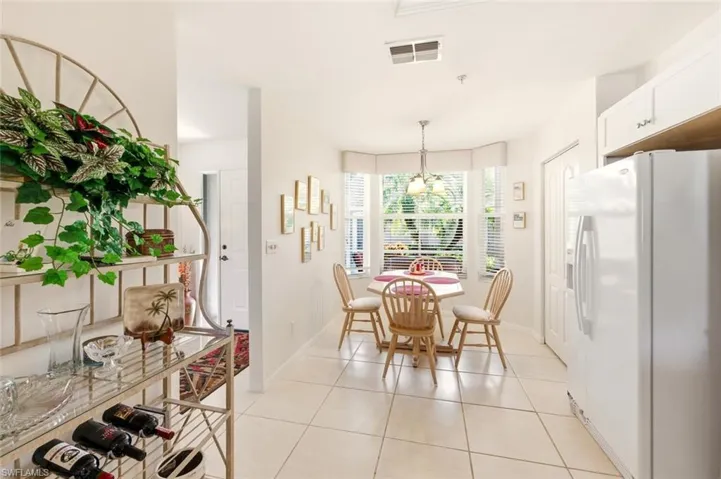 Dining area featuring light tile patterned flooring and baseboards