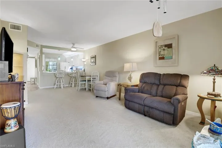 Living room with ceiling fan and carpet floors