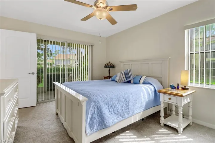 Carpeted bedroom featuring ceiling fan and access to outside