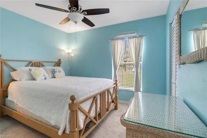 Carpeted bedroom with ceiling fan
