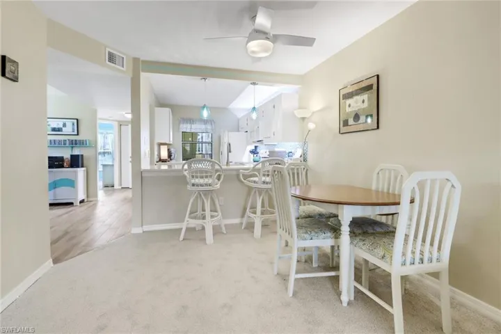 Dining area with light hardwood / wood-style floors and ceiling fan