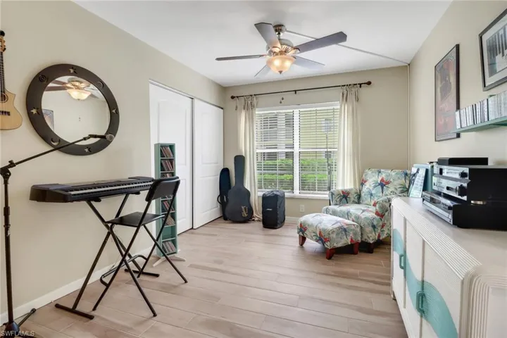 Office with ceiling fan and light hardwood / wood-style flooring