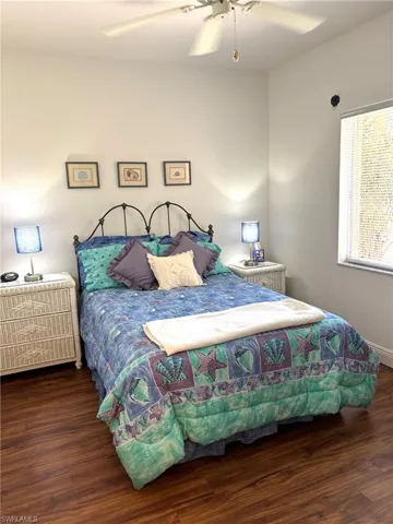 Bedroom featuring wood finished floors, ceiling fan, and baseboards
