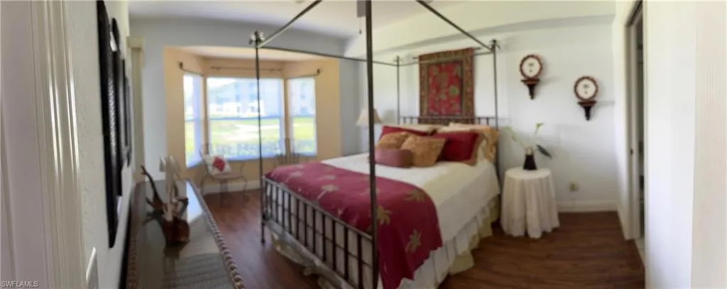 Bedroom featuring wood finished floors and baseboards