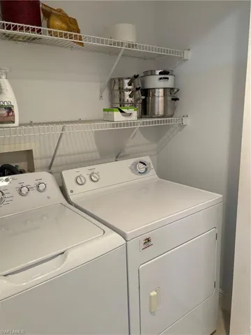 Washroom with washing machine and clothes dryer