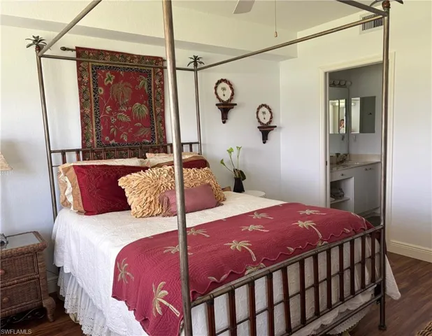 Bedroom featuring wood finished floors and ensuite bath