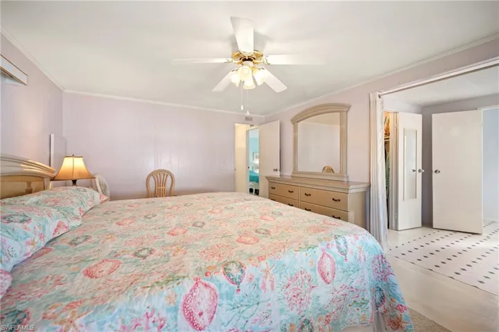 Bedroom with a ceiling fan and crown molding