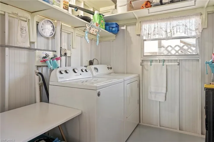 Laundry room with separate washer and dryer and finished concrete floors