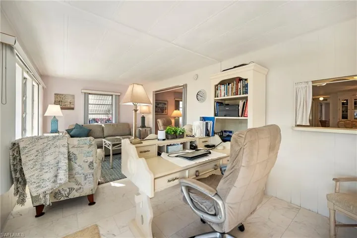Home office with light marble finish flooring