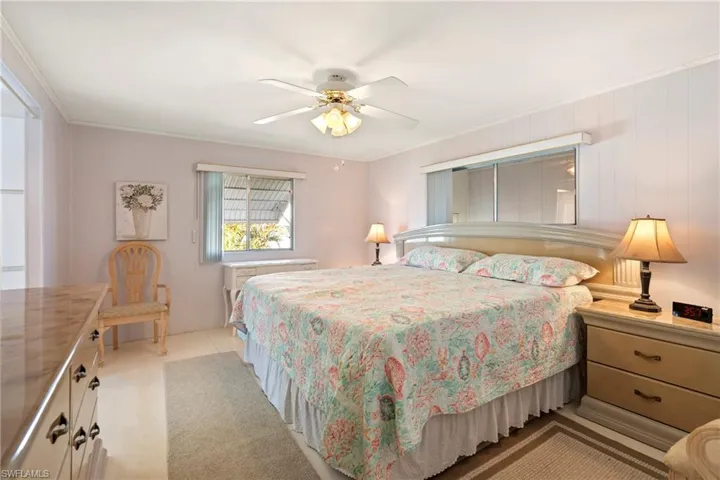Bedroom featuring ceiling fan and ornamental molding