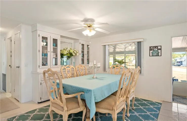 Dining area with a ceiling fan and light tile patterned floors