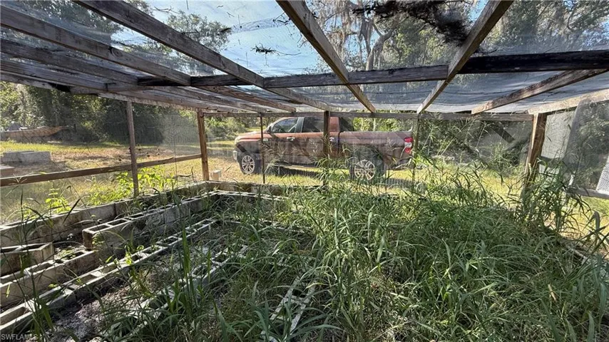 View of grassy yard featuring a patio