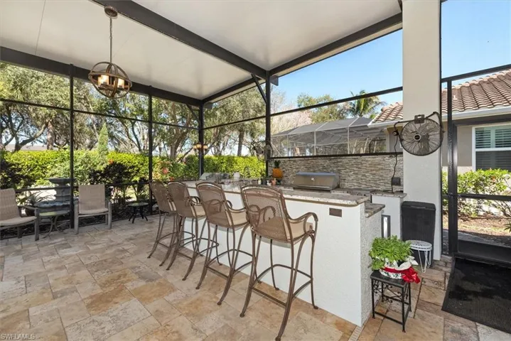 Sunroom / solarium featuring area for grilling, a patio, and plenty of natural light