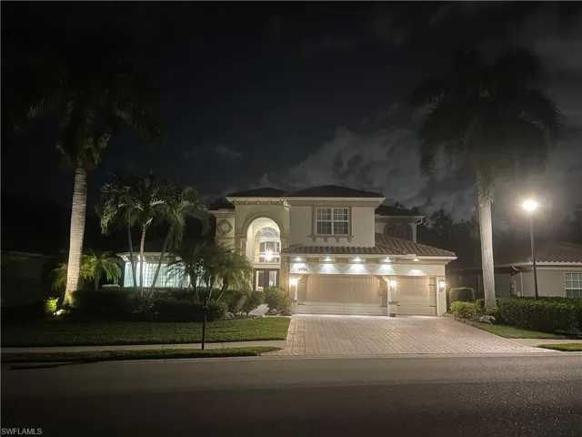Mediterranean / spanish-style house with stucco siding, driveway, and a garage