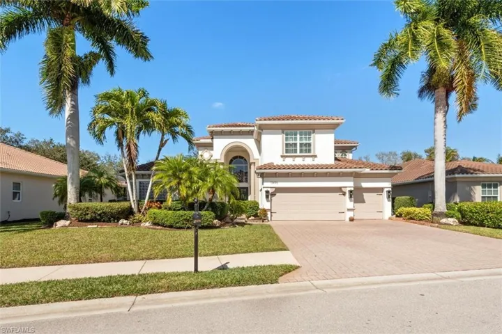 Mediterranean / spanish-style home featuring stucco siding, decorative driveway, a tiled roof, and a front yard