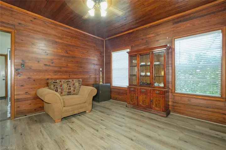Living area featuring wood walls, wooden ceiling, and hardwood / wood-style flooring
