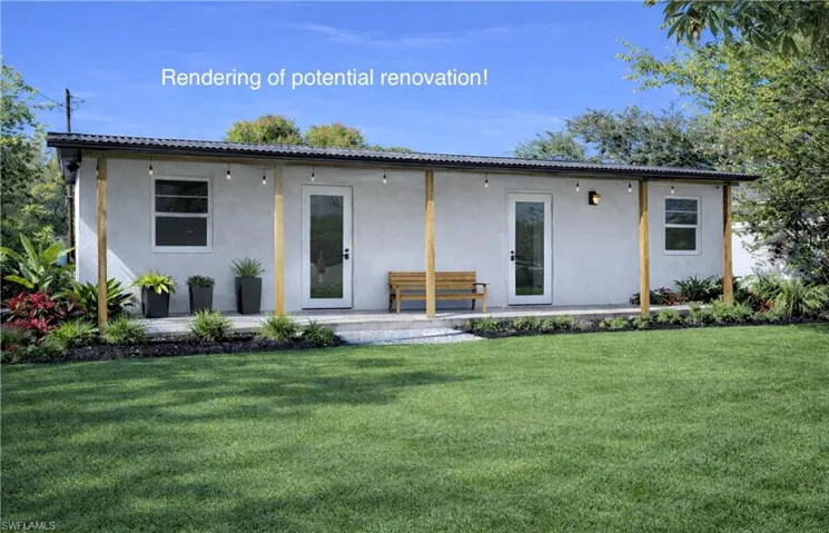 Rear view of house featuring a yard, stucco siding, and a patio