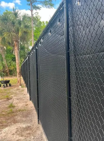 View of side of home featuring fence