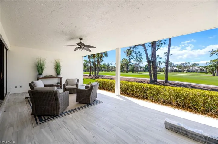 View of patio / terrace with a ceiling fan, outdoor furniture, and golf course view