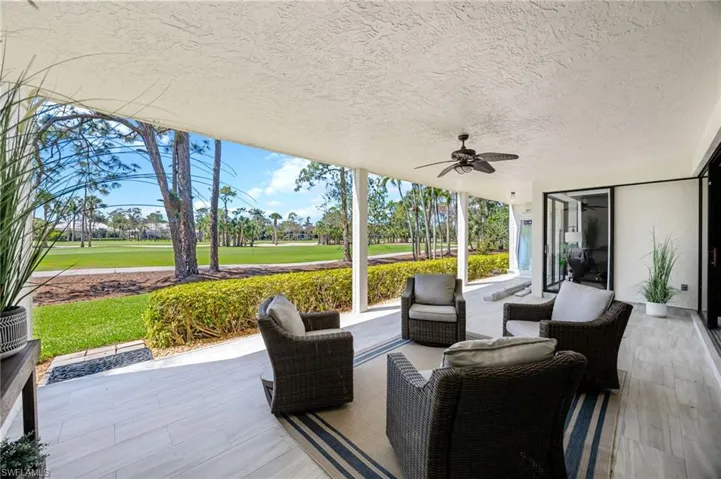 View of patio / terrace featuring ceiling fan, view of golf course, and outdoor furniture