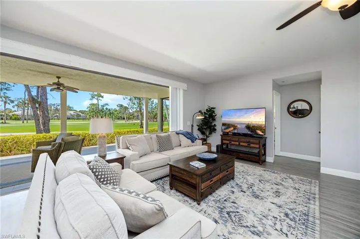 Living room with ceiling fan and wood finished floors