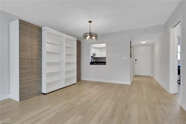 Living and Dining area with Murphy Bed/shelving unit