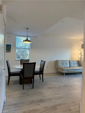Dining area featuring a textured ceiling and light wood-style flooring