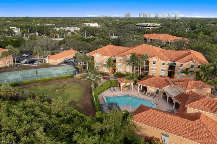 Aerial view of a pool area and a tree filled landscape